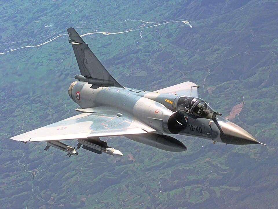 A French Air Force Mirage 2000C drops away from a United States Air Force KC-135R Stratotanker (not shown) after refueling during a Combat Patrol mission while